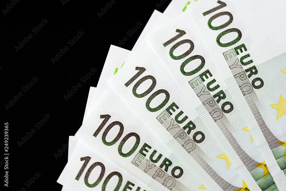 One Hundred euro banknotes on a dark background close up One Hundred euro banknotes on a dark background close up