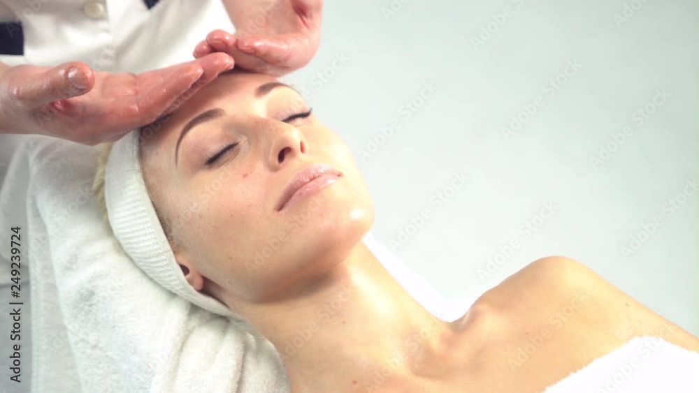 Young attractive woman getting spa treatment over white background Young attractive woman getting spa treatment over white background