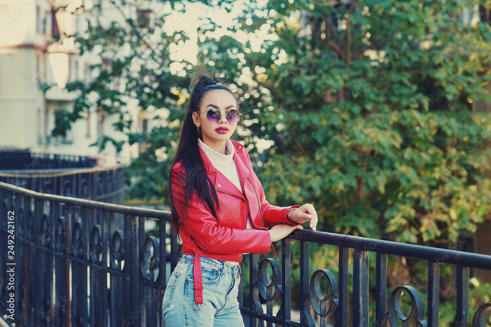 Beautiful young woman in trendy sunglasses on the street