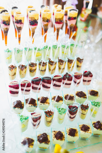 Delicious sweets on wedding candy buffet with desserts, cupcakes © olegparylyak