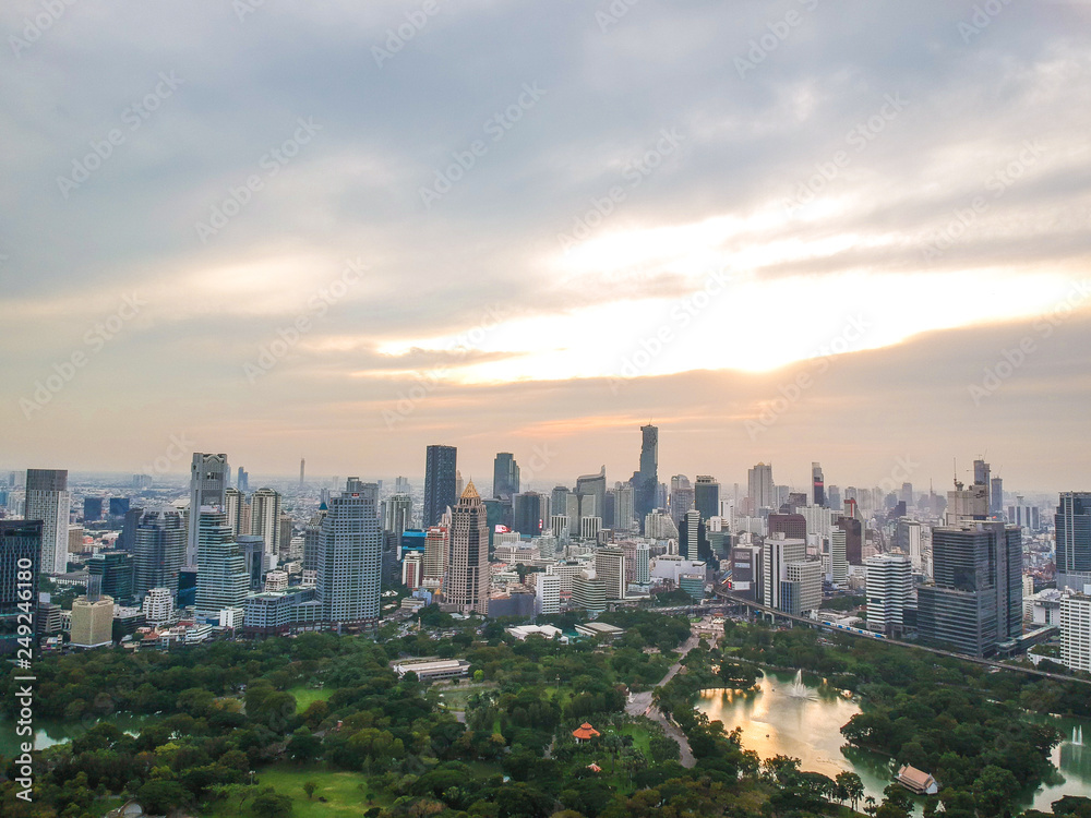 Fototapeta premium Aerial view city public park with modern building and fog