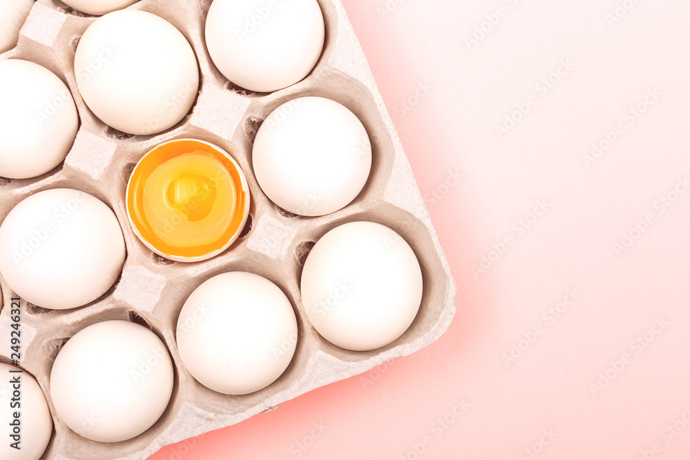 Eggs in egg box on pink background