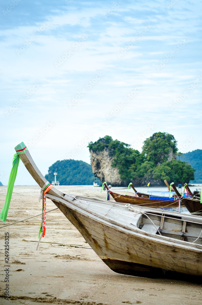 Long-tail boat parked on sand beach, Krabi province,Thailand.
