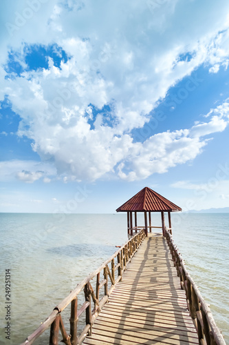 Little pavilion in the sea cloudy background.