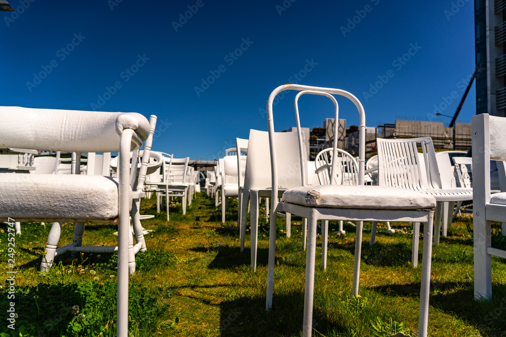 An installation of empty white chairs constitutes an unofficial temporary memorial for 185 people who died in the Canterbury earthquake, memorial in Christchurch New Zealand An installation of empty white chairs constitutes an unofficial temporary memorial for 185 people who died in the Canterbury earthquake, memorial in Christchurch New Zealand