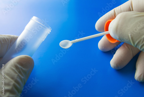 Doctor's hands with plastic container for analysis. Medical kit for the sampling of feces, coprology test. 