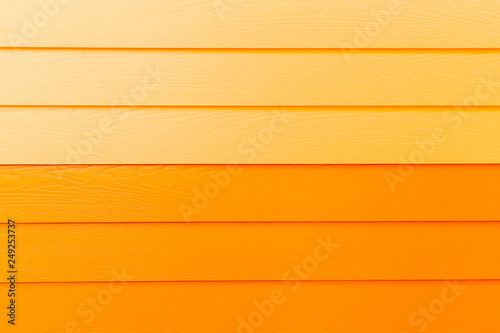 Wood orange background.orange Synthetic wood wall texture use for background.Colorful wooden board painted in orange. Wood background
