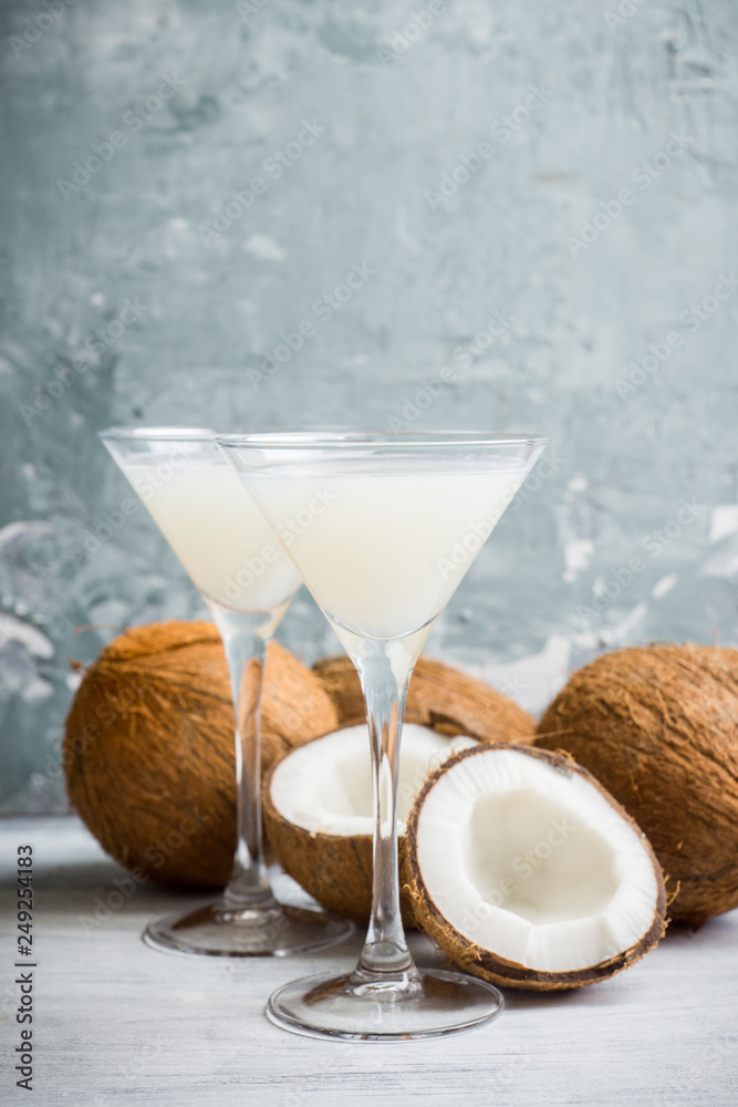 Sweet coconut cocktail in martini glass on the wooden background. Selective focus. Shallow depth of field. Sweet coconut cocktail in martini glass on the wooden background. Selective focus. Shallow depth of field.