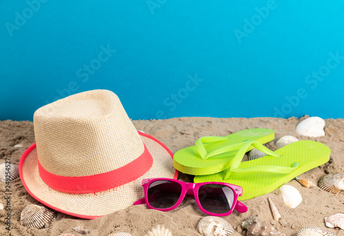 flip flops with sunglasses and strand hat
