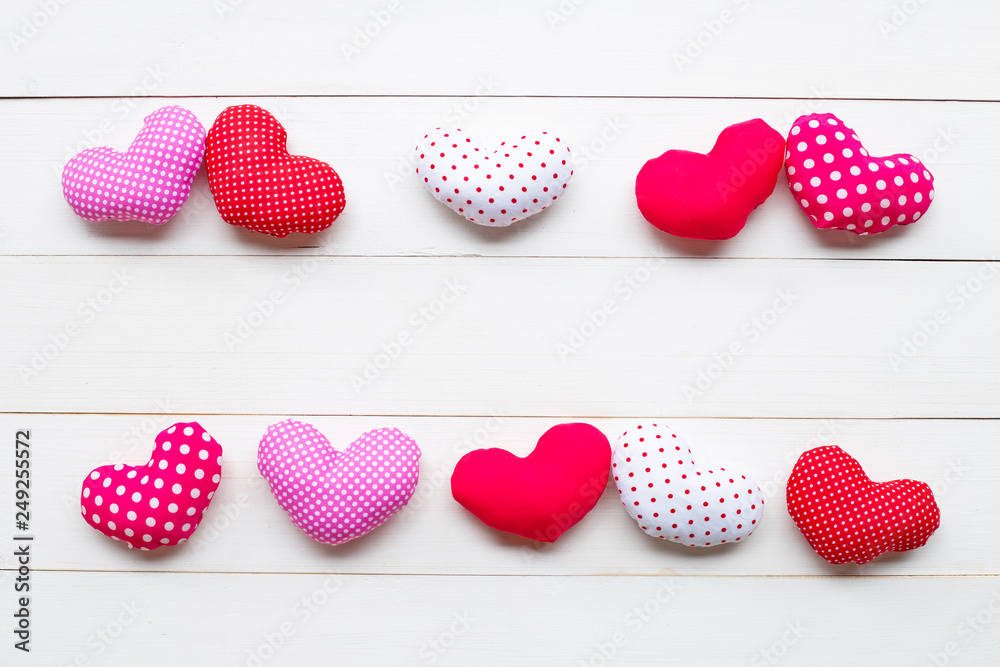 Valentine's hearts on white wooden background.