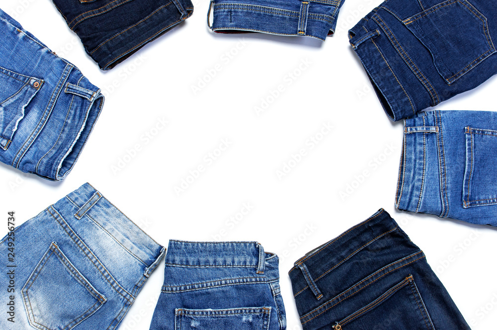 Frame of different blue jeans isolated on white background top view flat  lay. Detail of nice blue jeans. Jeans texture or denim background. Trend  clothing. Beauty and fashion, clothing concept. Stock Photo