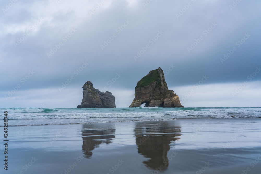 Rippled Sand and rock formations at Wharariki Beach, Nelson, North Island, New Zealand, Archway Islands, Natural wallpaper background, landscape photography, amazing stone formation