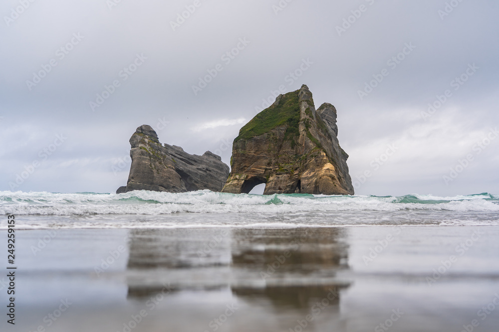 Rippled Sand and rock formations at Wharariki Beach, Nelson, North Island, New Zealand, Archway Islands, Natural wallpaper background, landscape photography, amazing stone formation