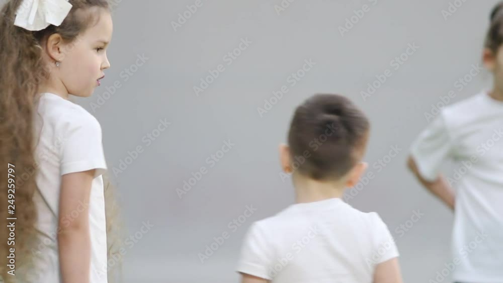 Indoor football arena. An angry little girl with long hair is shouting on a boy Indoor football arena. An angry little girl with long hair is shouting on a boy