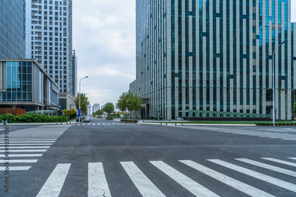 empty road with zebra crossing and skyscrapers in modern city. empty road with zebra crossing and skyscrapers in modern city.