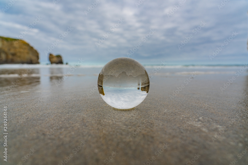 crystal ball on tunnel beach in New Zealand with rocks in the background, lansball on the beach, amazing tunnel beach in New Zealand with a crystal ball in the foreground, crystal ball on tunnel beach in New Zealand with rocks in the background, lansball on the beach, amazing tunnel beach in New Zealand with a crystal ball in the foreground,