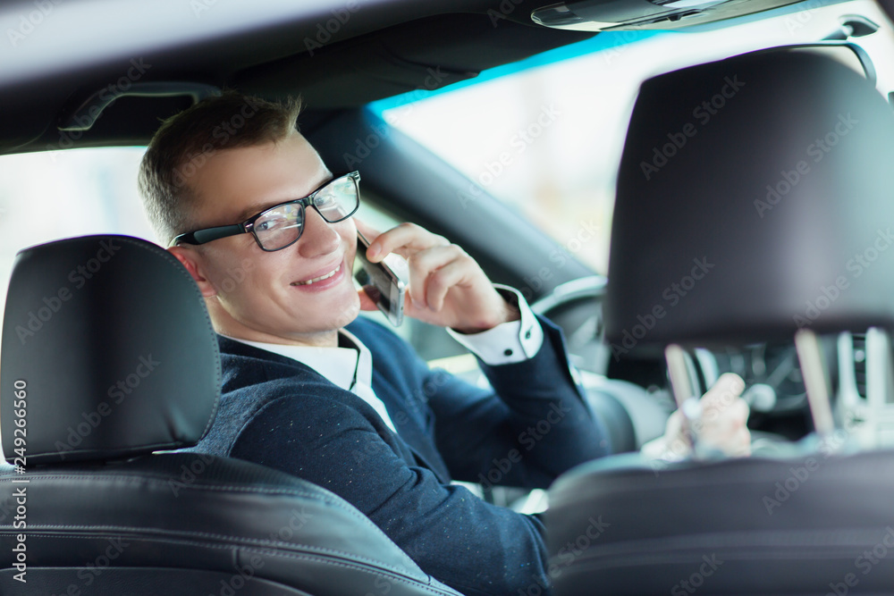 Close up. smiling businessman sitting in the car