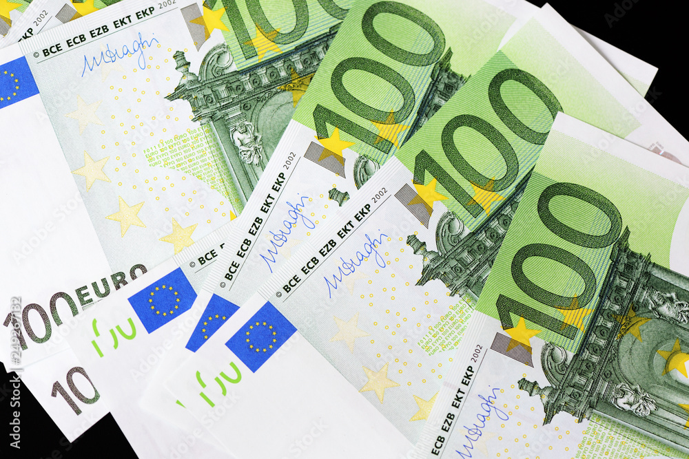 One Hundred euro banknotes on a dark background close up