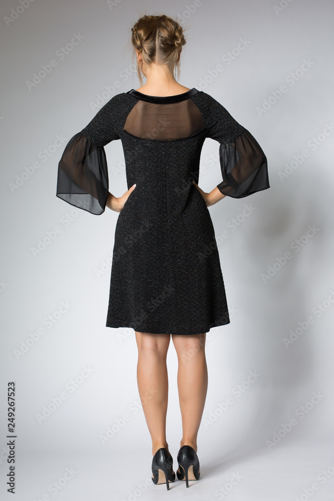 Beautiful blonde girl posing in luxury black dress Beautiful blonde girl posing in luxury black dress
