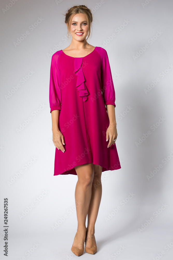 Beautiful blonde model posing in pink dress Beautiful blonde model posing in pink dress