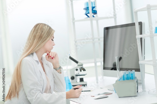 female scientist examines the data on the computer