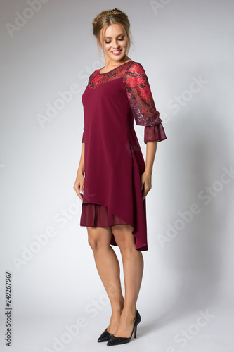 Beautiful model posing in fashion red dress