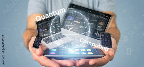 Businessman holding Quantum computing concept with qubit and devices 3d rendering