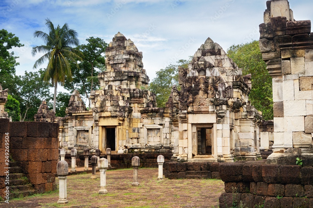 Fototapeta premium Сourtyard and libraries of 11th-century ancient Khmer temple Prasat Sdok Kok Thom built of red sandstone and laterite in Sa Kaeo province of Thailand