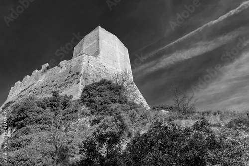 Beautiful black and white view of the Rocca d'Orcia against a dramatic sky, Siena, Tuscany, Italy photo