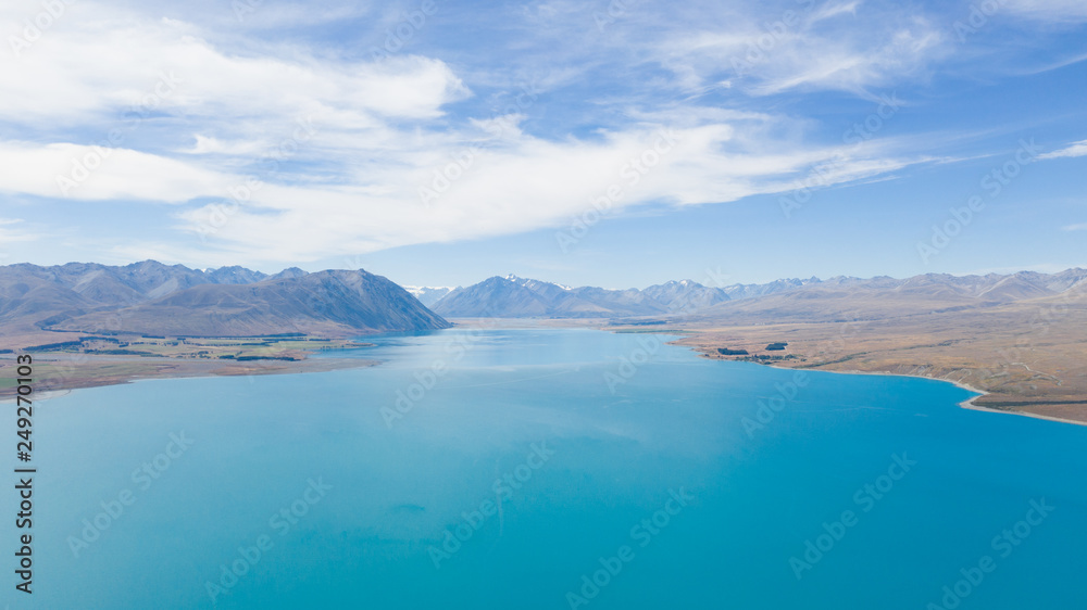 Lake tekapo from the air, aerial shot of the beautiful lake tekapro in New Zealand, stunning blue water lake in New Zealand, aerial photography of amazing nature, nature photography with a drone,