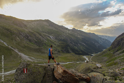 Man looking down to the valley in hohe tauern national park photo