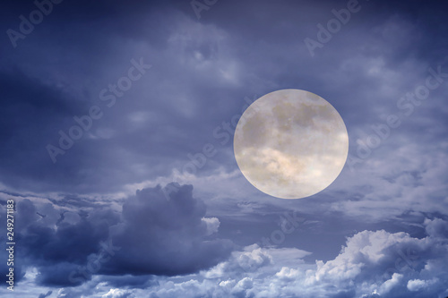The mystical full Moon in the clouds. Landscape of night nature at sunset. 