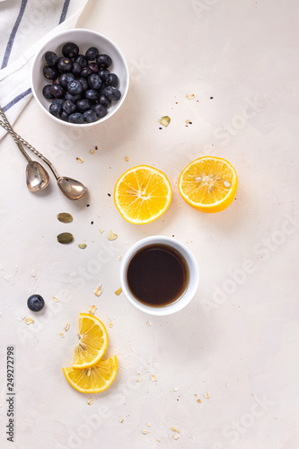 Happy morning breakfast healthy food concept on white background tea with lemon and blueberry. Flatlay.