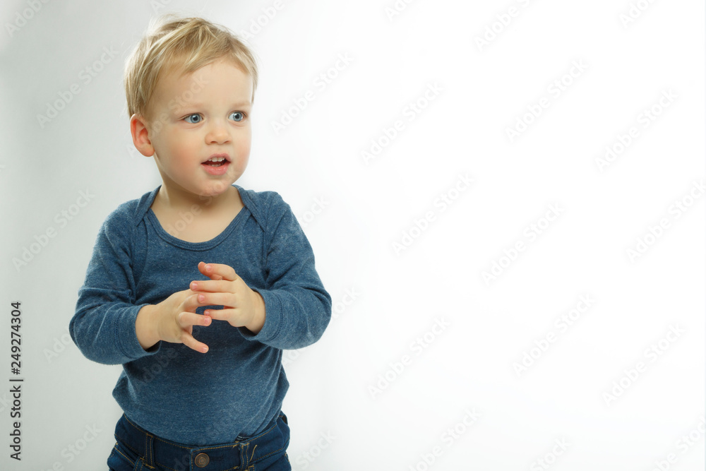 Shy baby boy on white background. Cute toddler with asking face expression. Adorable kid asking what is going on. Copy space. Shy baby boy on white background. Cute toddler with asking face expression. Adorable kid asking what is going on. Copy space.