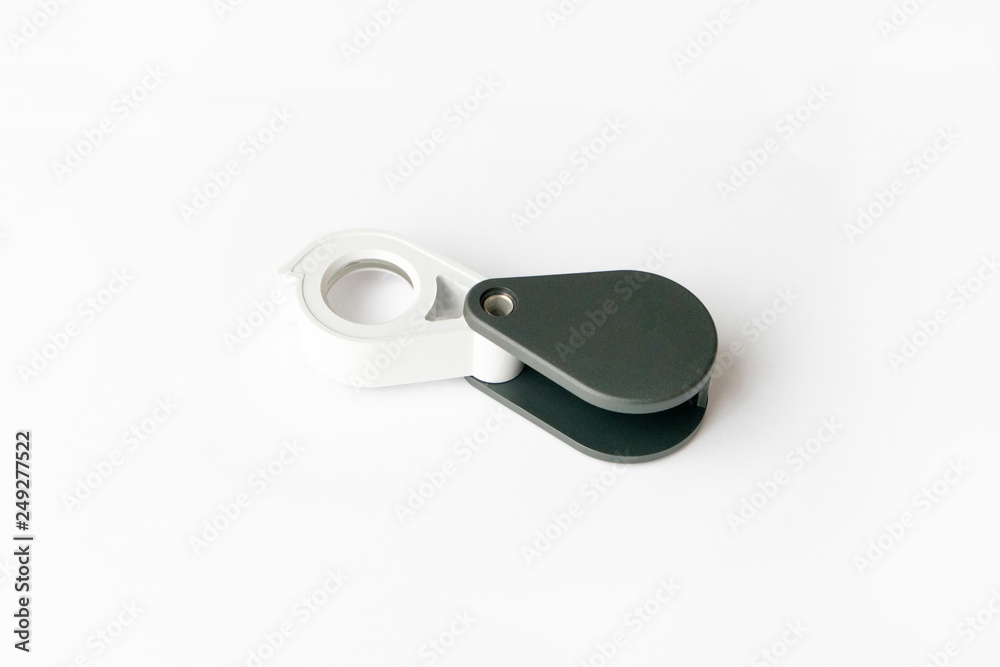 Magnifying glass for diamonds or see the amulet Isolated on a White Background. Magnifying glass for diamonds or see the amulet Isolated on a White Background.