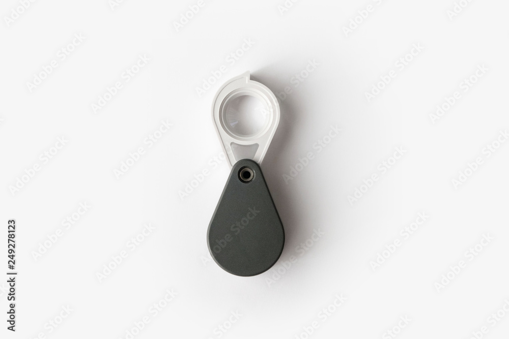 Magnifying glass for diamonds or see the amulet Isolated on a White Background. Magnifying glass for diamonds or see the amulet Isolated on a White Background.