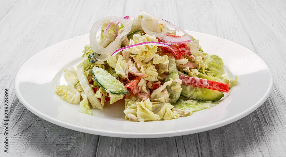 Salad from smoked sausage, spicy carrot, tomato, cucumber and spices, dressed with mayonnaise