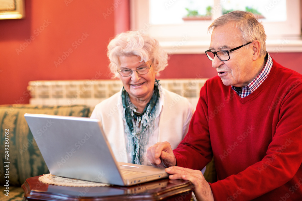 Senior couple reading news from the internet Senior couple reading news from the internet