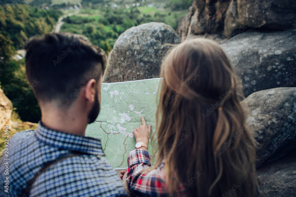 Fototapeta premium Hipster couple in love having fun together posing in mountain.