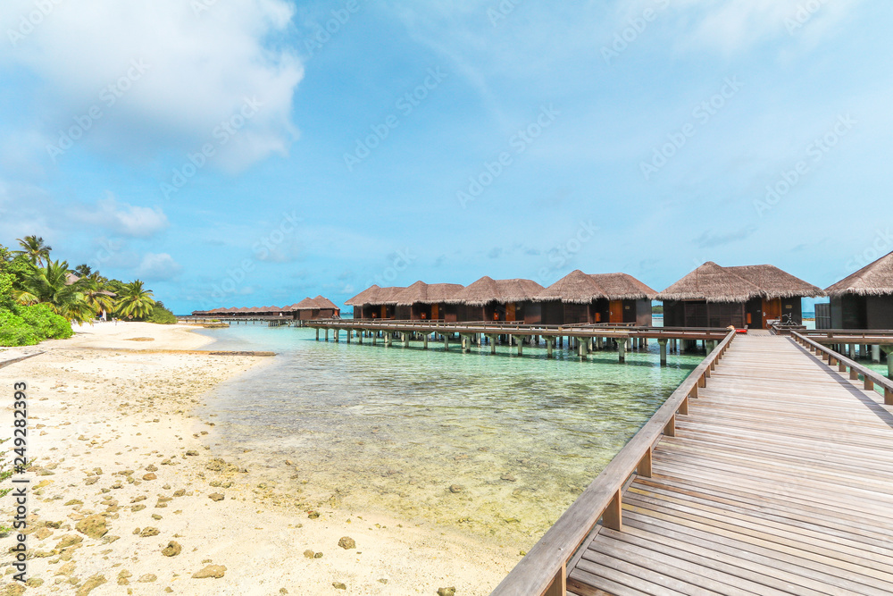 Amazing island in the Maldives ,wooden bridge and  beautiful  turquoise waters with  blue sky  background for for holiday ,summer, vacation .
