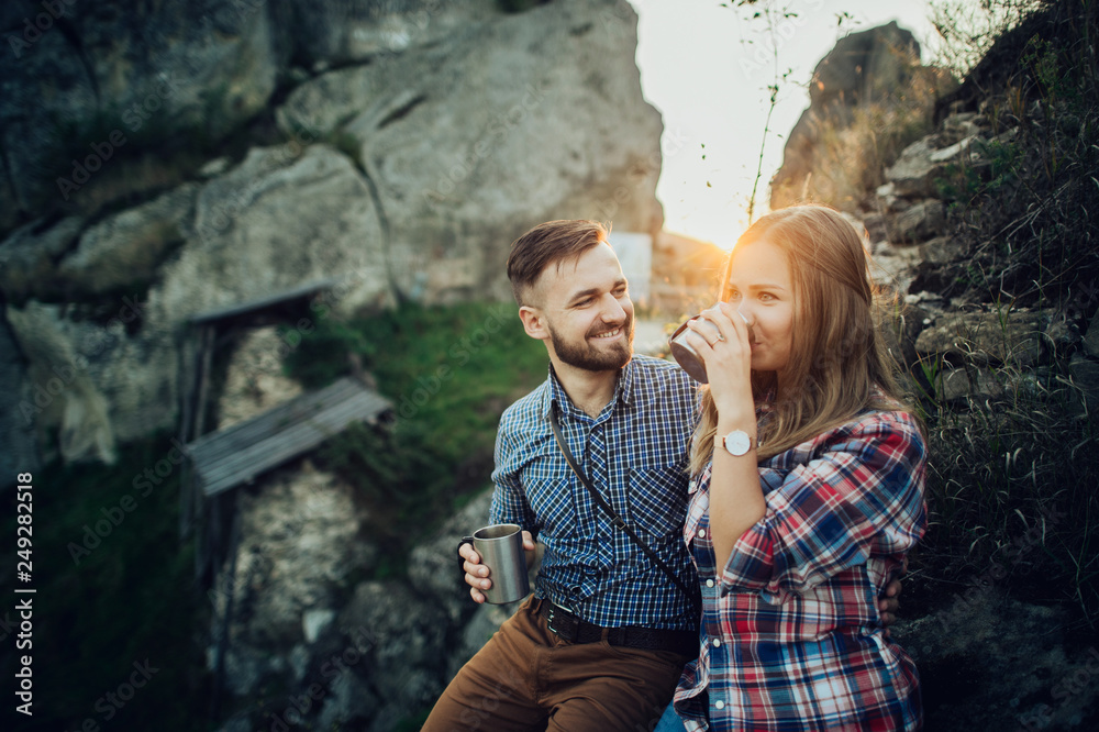 Hipster couple in love having fun together posing in mountain.