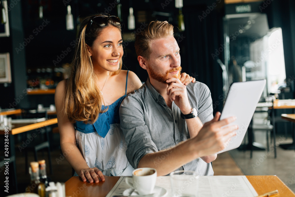 Beautiful couple looking at tablet