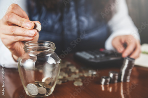 woman hand coins with calculator