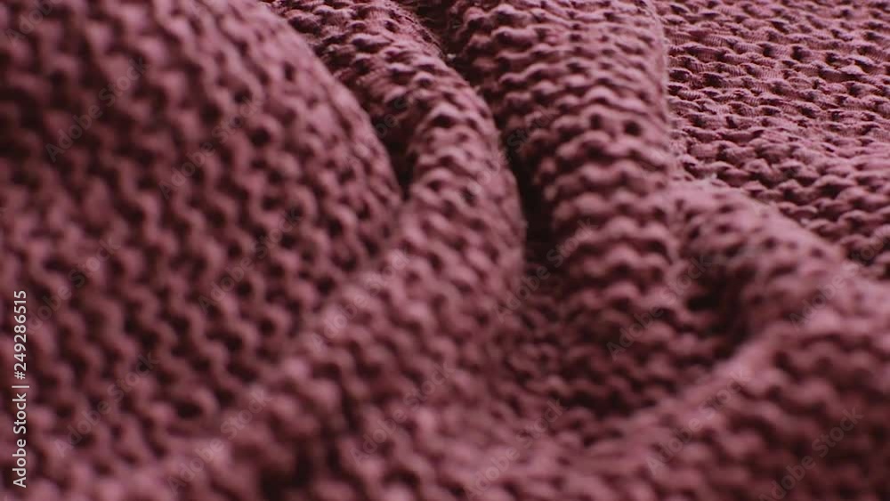 The texture of the fabric. Maroon knitted texture. Close-up. Can be used as a background. Hd