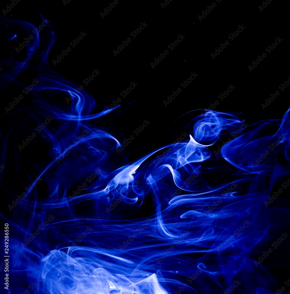 Fototapeta premium Blue smoke on black background