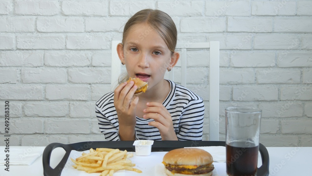Child Eating Hamburger, Kid in Fast Food Restaurant, Girl Drinking Juice Child Eating Hamburger, Kid in Fast Food Restaurant, Girl Drinking Juice