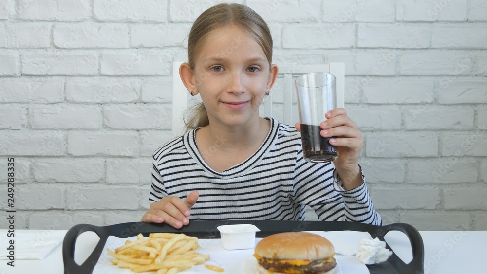 Child Eating Hamburger, Kid in Fast Food Restaurant, Girl Drinking Juice Child Eating Hamburger, Kid in Fast Food Restaurant, Girl Drinking Juice