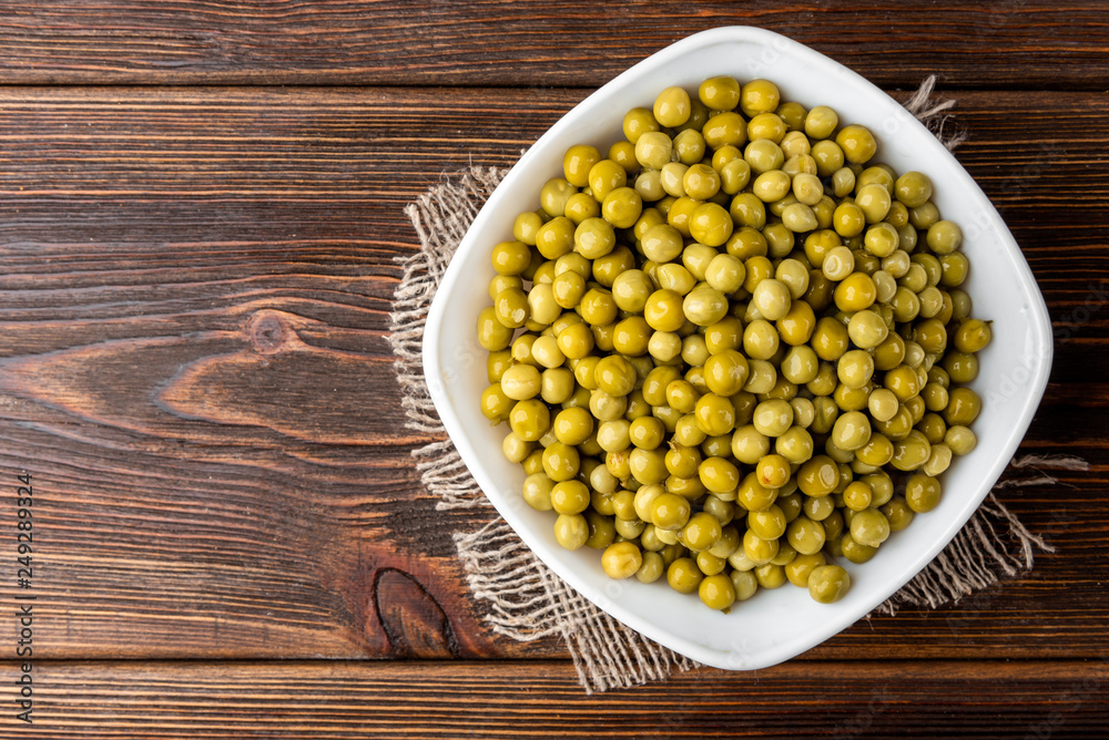 Canned green peas on dark wooden background. Canned green peas on dark wooden background.