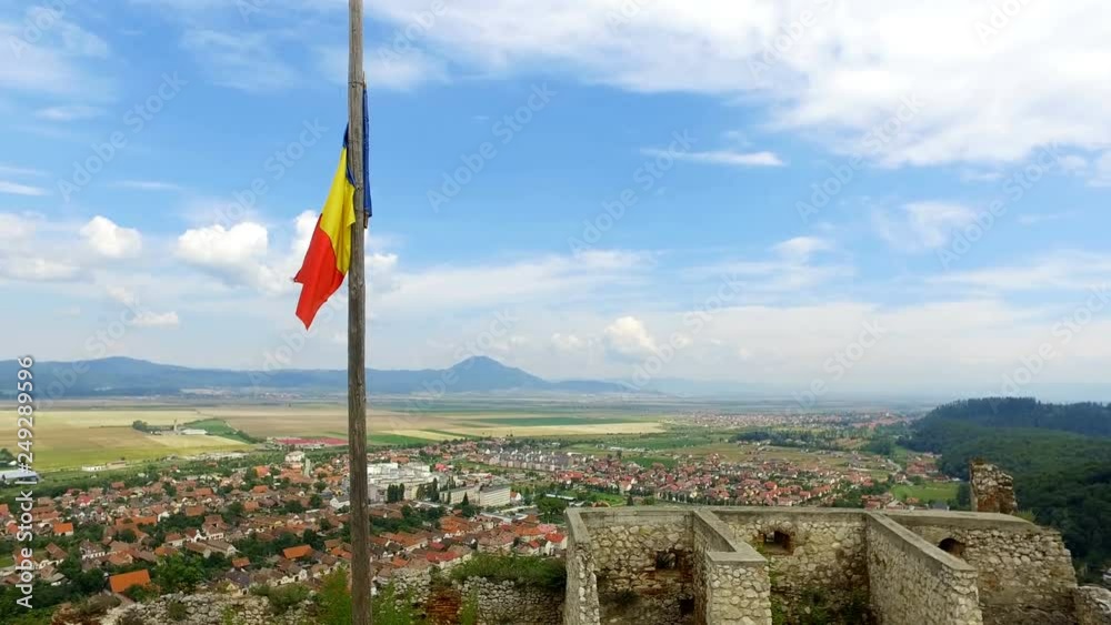 Romanian Flag with Rasnov city in the background Romanian Flag with Rasnov city in the background