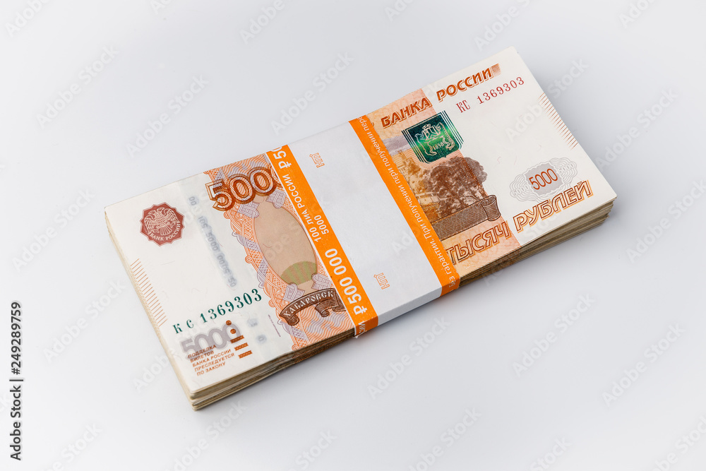 Large stack of banknotes, Russian rubles isolated on white background, packed stack of banknotes 5000 rubles, five hundred thousand Large stack of banknotes, Russian rubles isolated on white background, packed stack of banknotes 5000 rubles, five hundred thousand